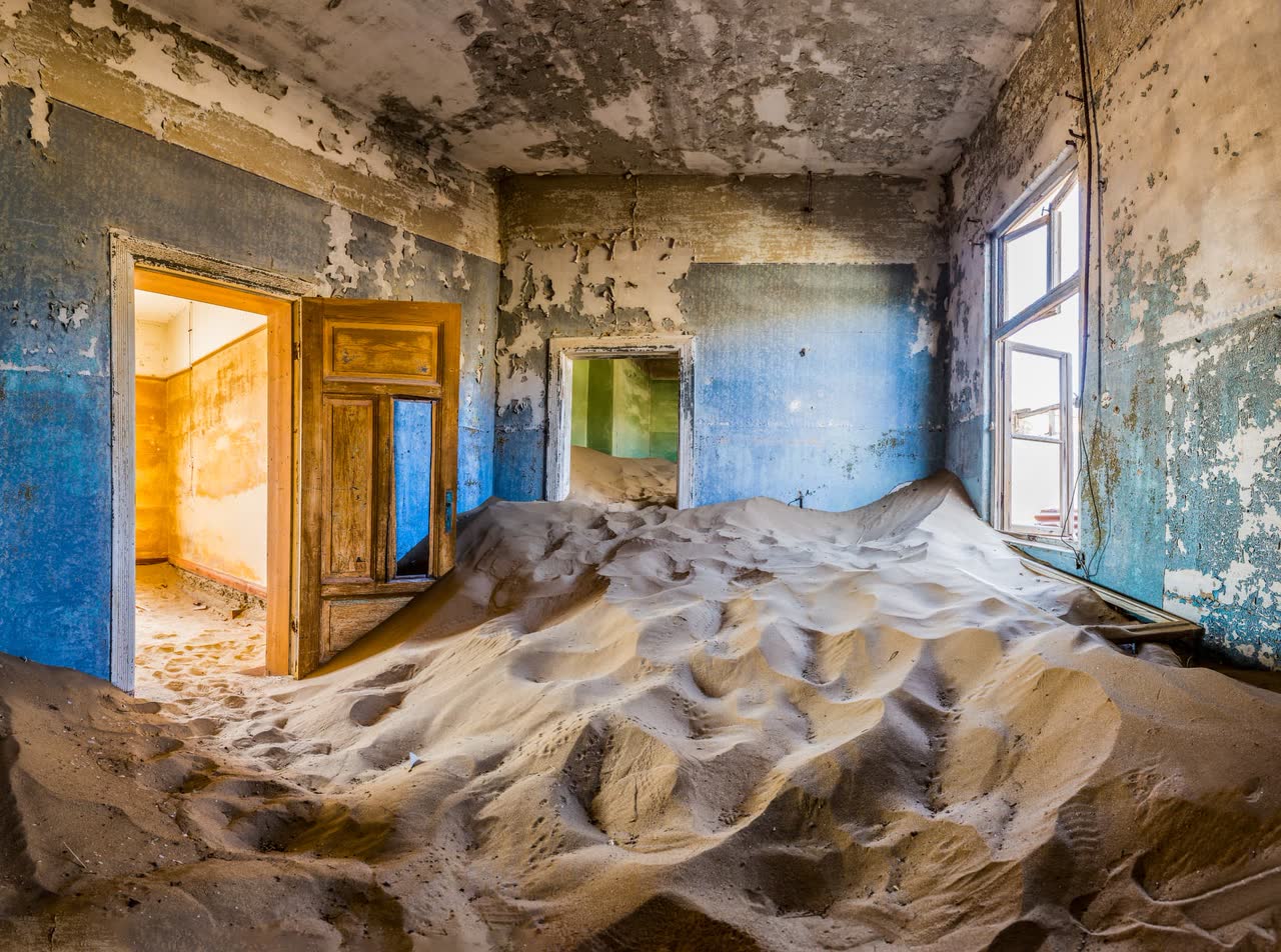 A sand-filled room in the abandoned diamond town of Kolmanskop